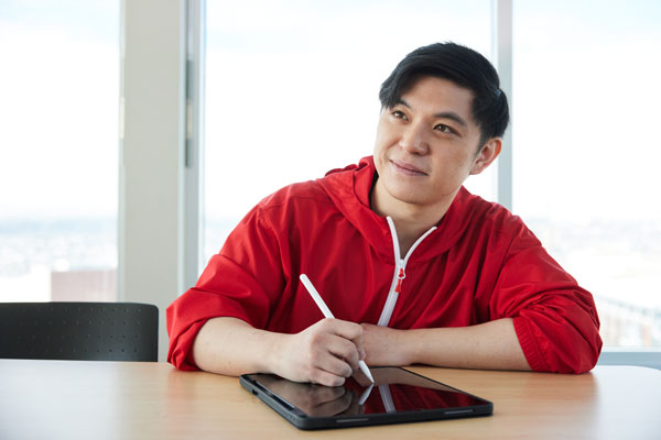 Person writing on a tablet